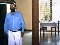 Paul standing next to pillar that is coiled with rope (as in the picture a brother had for us before leaving NZ) at the Blue Water Resort Dining room.